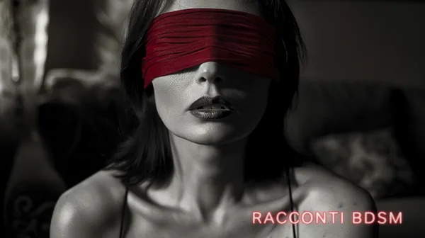 Primo piano di una donna con gli occhi coperti da una fascia rossa, in un ambiente buio con illuminazione laterale.